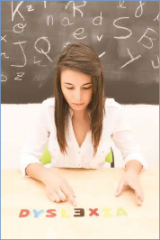 The photo shows a  student re-arranging letters, trying to correctly spell dyslexia.