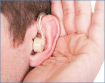 The photo shows a close-up of somebody wearing a hearing aid.