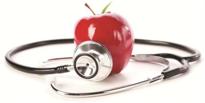 The photo shows a shiny red apple, with a stethoscope applied to it.