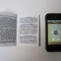 textbook next to a phone,witha photo of the text in a OCR app
