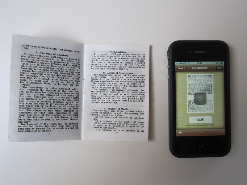 textbook next to a phone,witha photo of the text in a OCR app