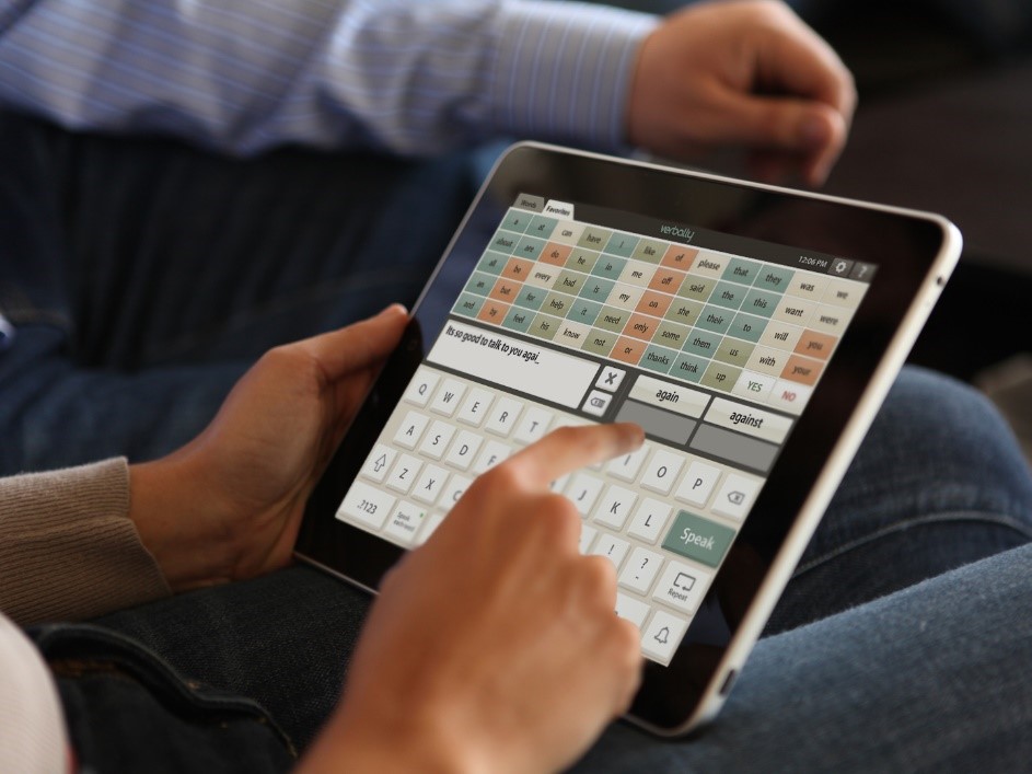 Two person sitting together as one person is using the Verbally app on their iPad 